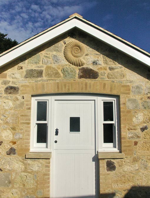 Playground Sculptures Large Ammonite Fossil inset in gable end of house